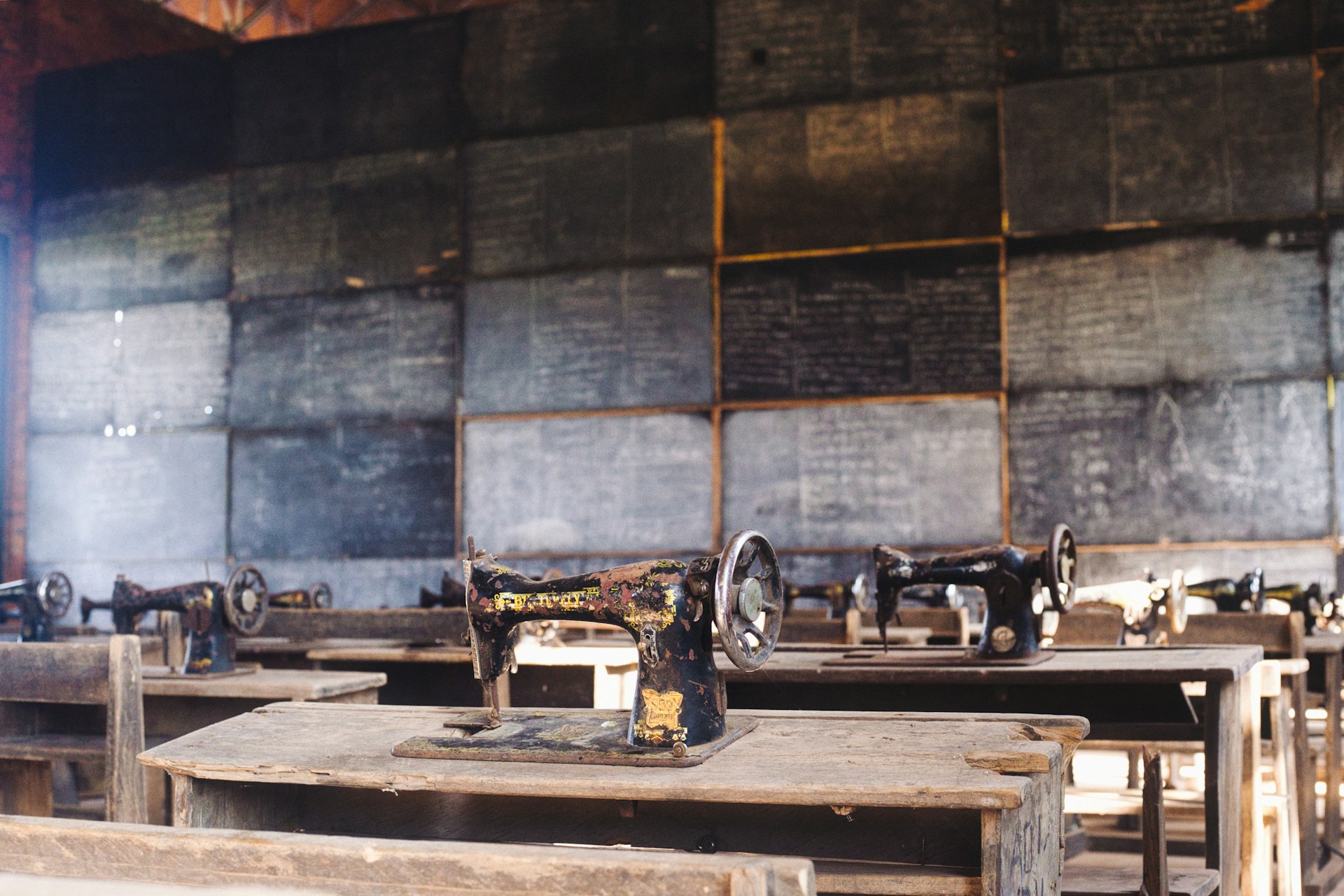 A workshop room lined with sewing machines